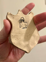 Raccoon on a Plaque